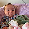 baby, infant, smiling, blanket, floral_clothing, cozy, cute, portrait, indoors, soft_texture, child, wrapped, happy, face, head, hand, newborn, warm, comfort, person