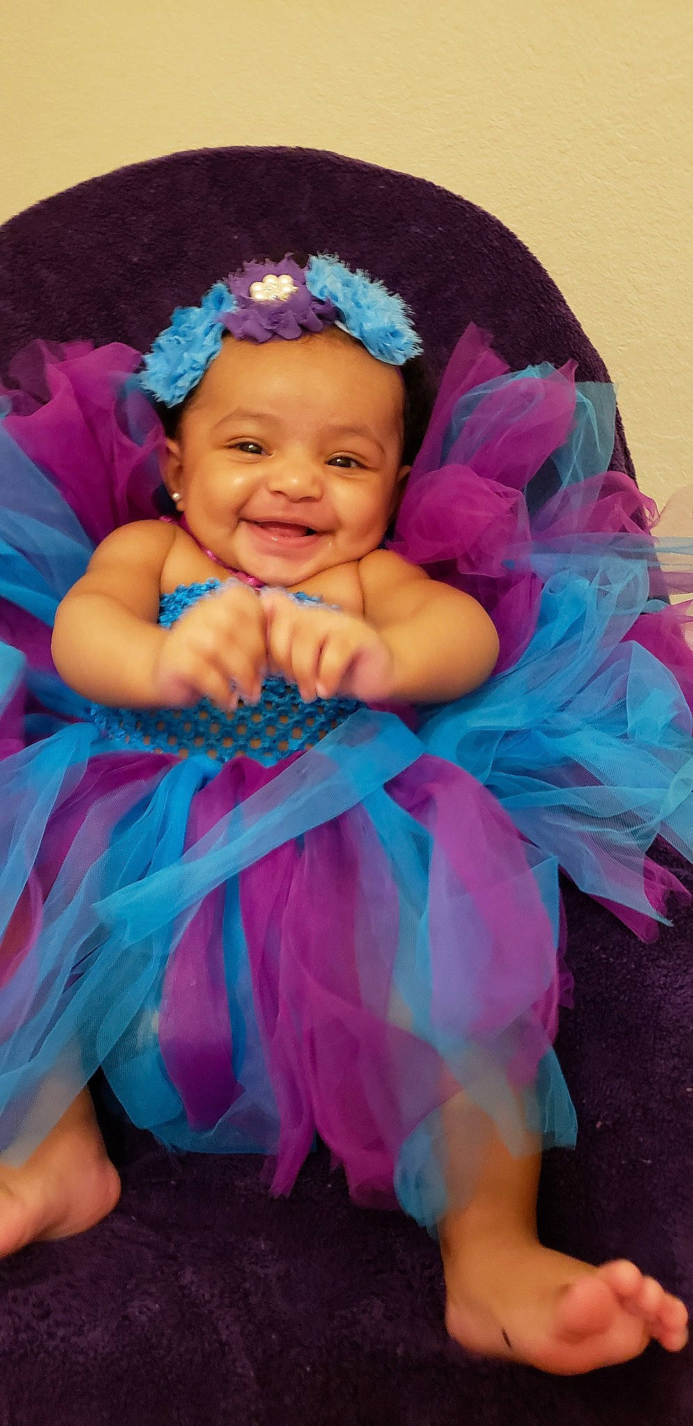 Giana is registered to the contest to win money with this photo: baby, child, clothing, costume, fashion_accessory, hair_accessory, headgear, joy, magenta, person, pink, purple, toddler, turquoise