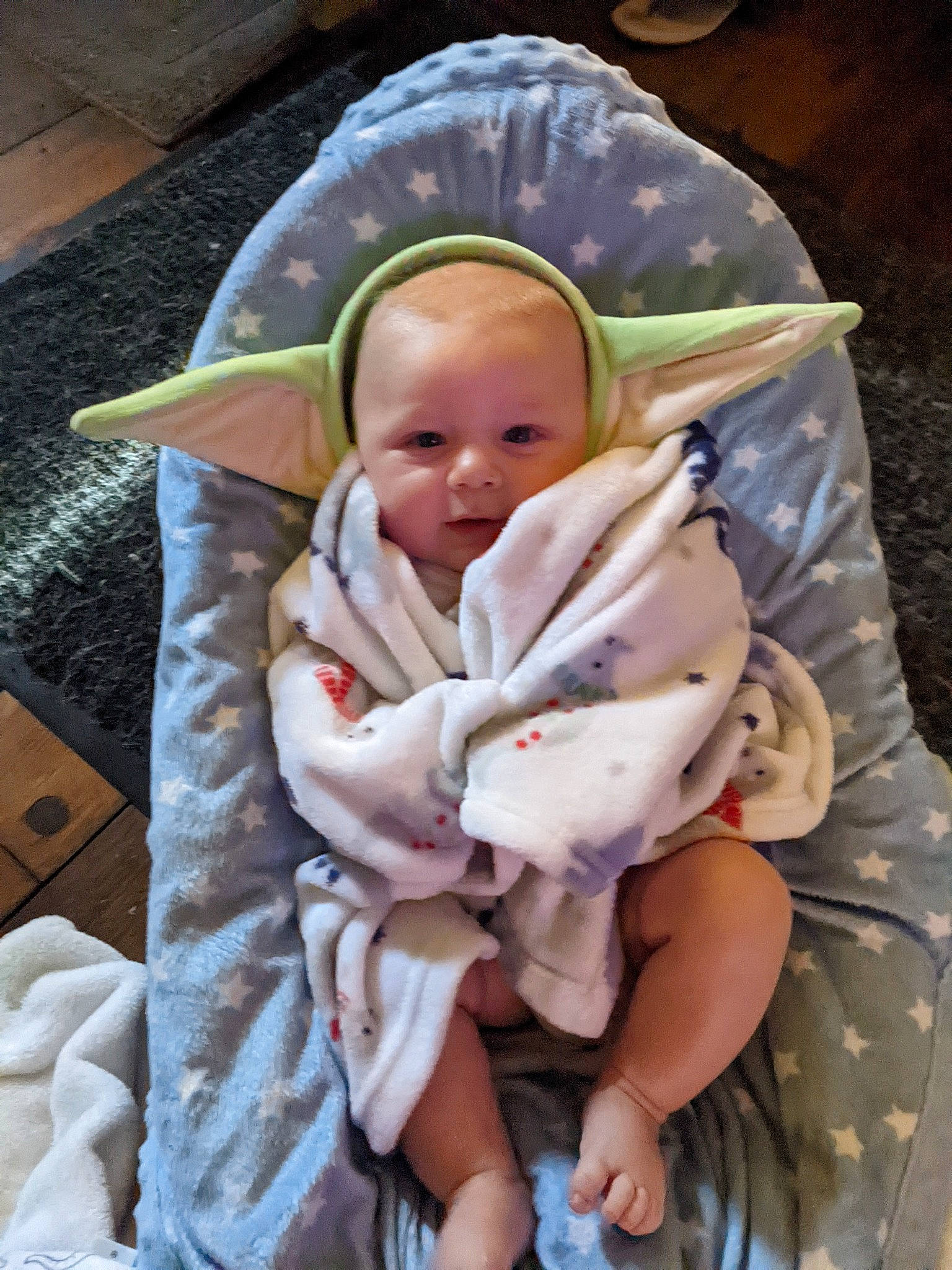 Oliver is registered to the contest to win money with this photo: baby, baby_products, baby_safety, baby_toddler_clothing, cheek, child, comfort, face, infant_bed, linens, person, product, room, sitting, textile, thumb, toddler