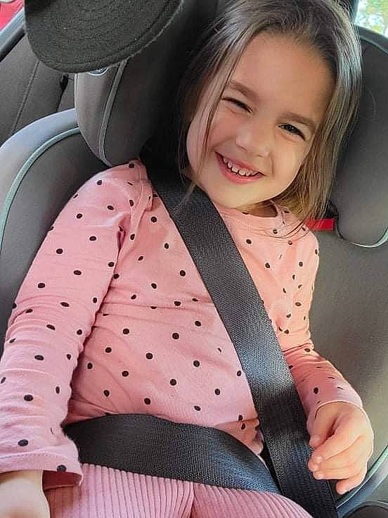 Melody joined the competition — help win amazing prizes! arm, face, facial_expression, happy, human_body, joy, leg, motor_vehicle, neck, organ, person, pink, product, skin, sleeve, smile, steering_wheel, thigh, toddler, vehicle_door