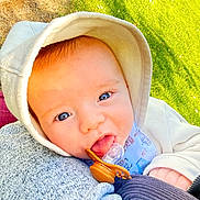 Myles joined the competition — help win amazing prizes! baby, blanket, blue_eyes, child, close_up, clothing, cozy, cute, eyes, face, grass, hood, human, infant, lying_down, outdoor, pacifier, photography, portrait, sunlight
