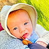 baby, blanket, blue_eyes, child, close_up, clothing, cozy, cute, eyes, face, grass, hood, human, infant, lying_down, outdoor, pacifier, photography, portrait, sunlight
