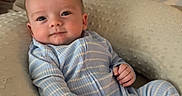 Myles joined the competition — help win amazing prizes! baby, bed, bedding, bedroom, blanket, blue_clothing, child, cozy, face, happy, indoors, infant, lying_down, pajamas, photography, pillow, portrait, sitting, smiling, striped_clothing
