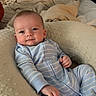baby, bed, bedding, bedroom, blanket, blue_clothing, child, cozy, face, happy, indoors, infant, lying_down, pajamas, photography, pillow, portrait, sitting, smiling, striped_clothing