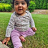 baby, child, grass, outdoor, garden, greenery, trees, bushes, smiling, curly_hair, long_sleeve_shirt, purple_pants, barefoot, sitting, cute, young, nature, daylight, happy, portrait