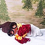 baby, child, glasses, knit_hat, scarf, blanket, white, red, yellow, brown, portrait, indoor, lying_down, cute, soft, cozy, face, smiling, infant, person