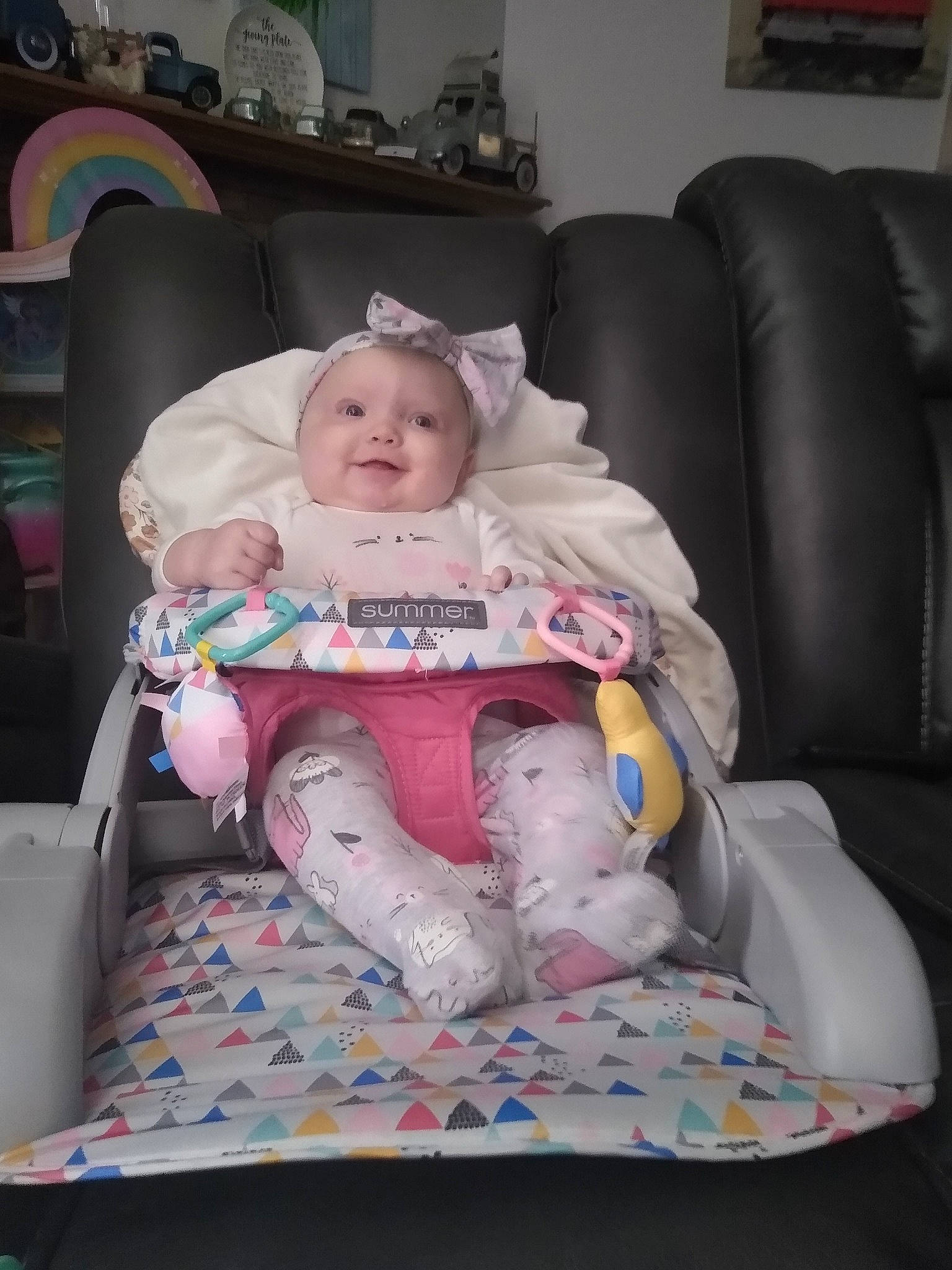 Alexa is registered to the contest to win money with this photo: baby, baby_carriage, baby_products, baby_toddler_clothing, car_seat, cheek, child, comfort, couch, fun, human_body, lap, leg, living_room, person, picture_frame, room, sitting, skin, thigh