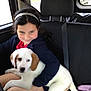 black_hair, car, child, clothing, cuddle, cute, dog, friendship, headband, indoor, love, paper, pet, puppy, seat, seatbelt, smile, transportation, travel, window