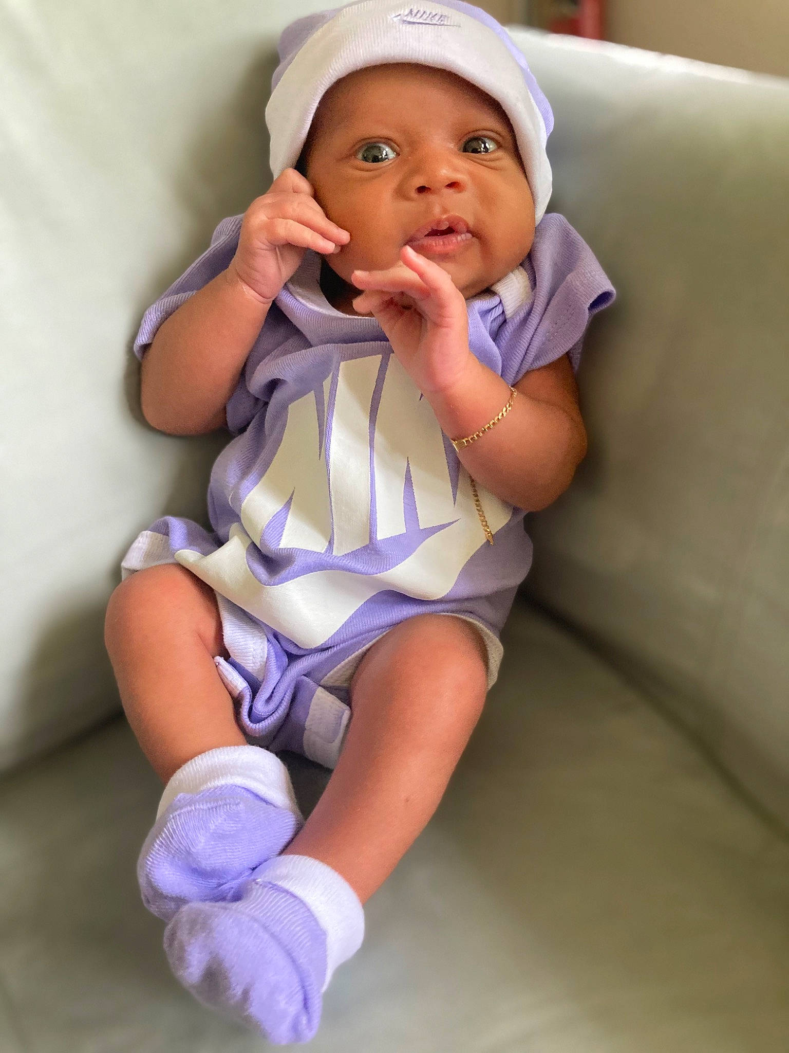 Nygeri is registered to the contest to win money with this photo: baby, baby_toddler_clothing, cap, cheek, child, comfort, face, finger, human_leg, knee, leg, lip, person, pink, purple, skin, sleeve, sock, thigh, thumb