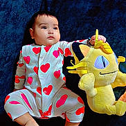 Yuvaan joined the competition — help win amazing prizes! baby, child, onesie, hearts, plush_toy, yellow, cute, infant, lying_down, blue_background, soft_toy, foot, hand, face, expression, indoors, comfort, sleepwear, adorable, portrait