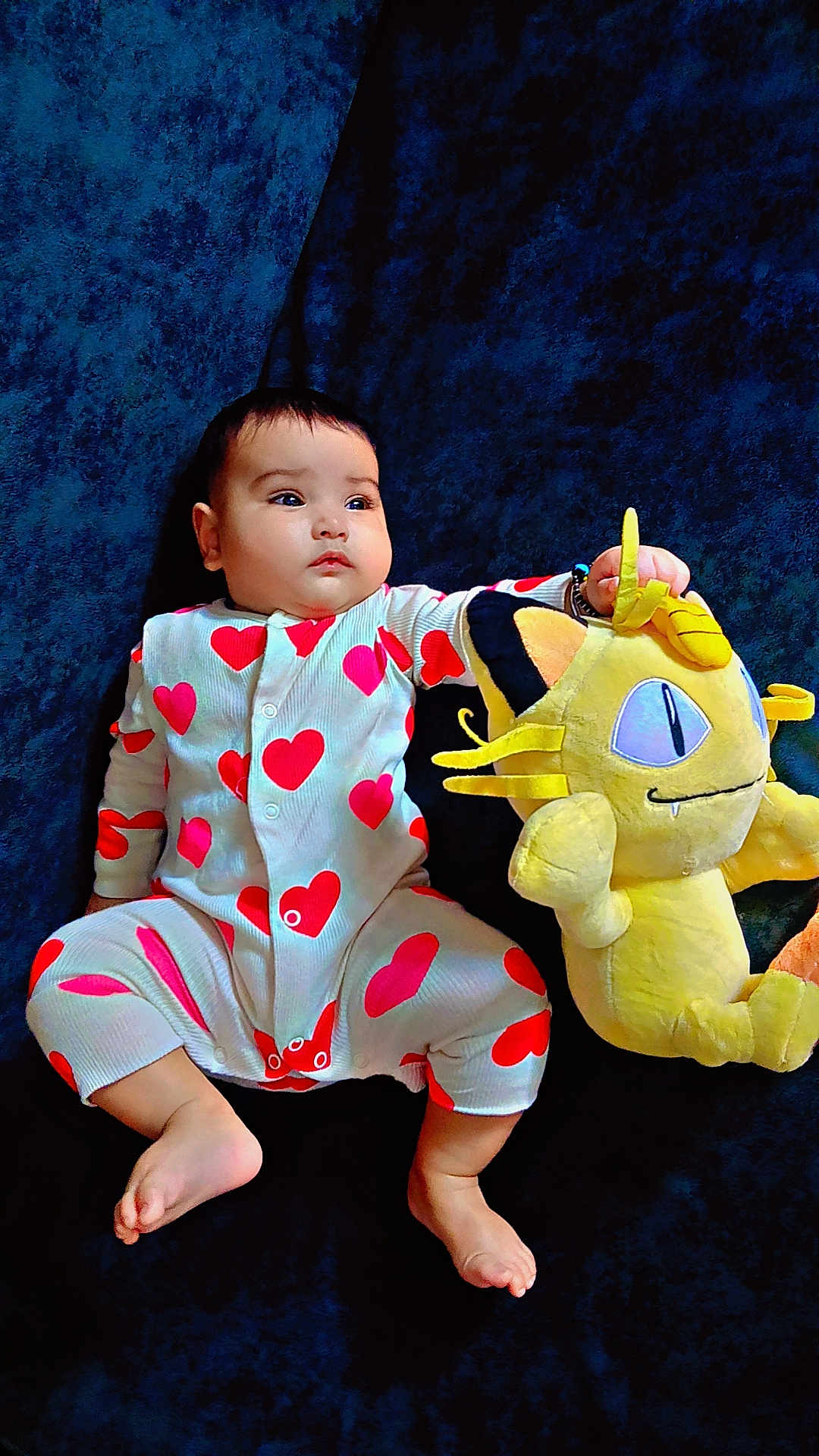 Yuvaan joined the competition — help win amazing prizes! baby, child, onesie, hearts, plush_toy, yellow, cute, infant, lying_down, blue_background, soft_toy, foot, hand, face, expression, indoors, comfort, sleepwear, adorable, portrait