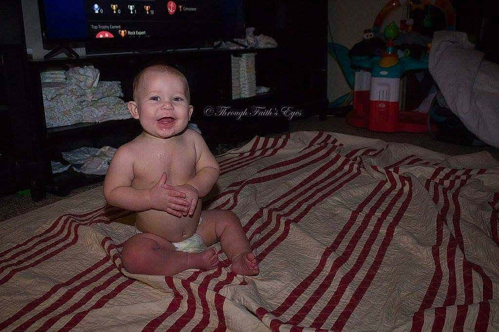 Maximus is registered to the contest to win money with this photo: baby, child, crawling, electronic_device, floor, flooring, fun, person, room, sitting, toddler