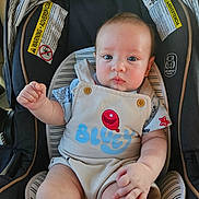 Alistair joined the competition — help win amazing prizes! baby, child, infant, car_seat, overalls, blue_eyes, clothing, cute, chubby, sitting, indoor, warning_labels, safety, stripes, red_balloon, pale_skin, short_hair, hand, face, portrait