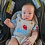 baby, child, infant, car_seat, overalls, blue_eyes, clothing, cute, chubby, sitting, indoor, warning_labels, safety, stripes, red_balloon, pale_skin, short_hair, hand, face, portrait