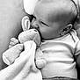 baby, black_and_white, blanket, child, clothing, comfort, cute, expression, fabric, face, hand, indoors, infant, lying_down, monochrome, person, plush_toy, portrait, soft_toy, toddler