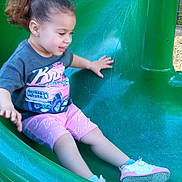 Izabella joined the competition — help win amazing prizes! child, toddler, slide, playground, green_slide, smiling, shorts, tshirt, shoes, sneakers, play, outdoor, fun, happy, hair_tie, wood_chips, park, summer, active, cute