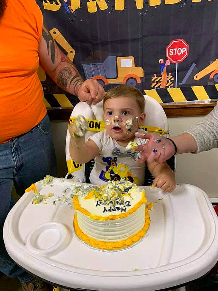 Colton is registered to the contest to win money with this photo: baked_goods, birthday_cake, buttercream, cake, cake_decorating, cake_decorating_supply, chair, cream, cuisine, dessert, food, fun, icing, person, plate, sugar_cake, sugar_paste, t_shirt, table, tableware