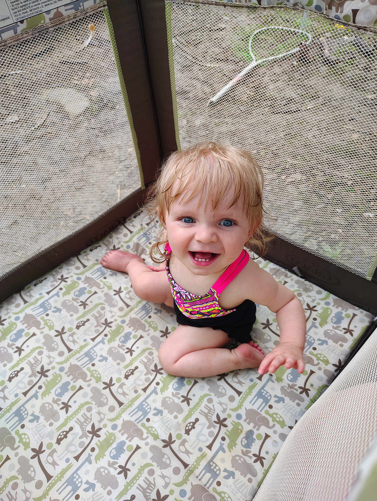 Renesmee joined the competition — help win amazing prizes! toddler, child, playpen, mesh, animal_pattern, blue_eyes, blond_hair, smiling, happy, sitting, outdoor, toy, racket, colorful_clothing, pink_strap, barefoot, padded_floor, baby, young_child, curly_hair