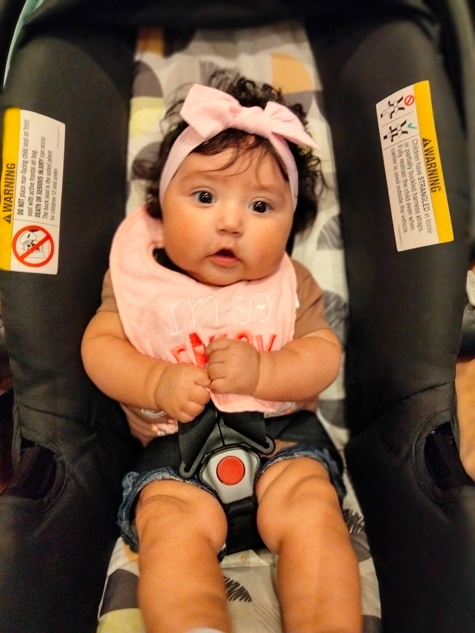 Marisol is registered to the contest to win money with this photo: baby, baby_carriage, baby_products, baby_safety, baby_toddler_clothing, car_seat, cheek, child, comfort, eye, fun, happy, headwear, human_leg, knee, lap, person, product, sitting, surprise