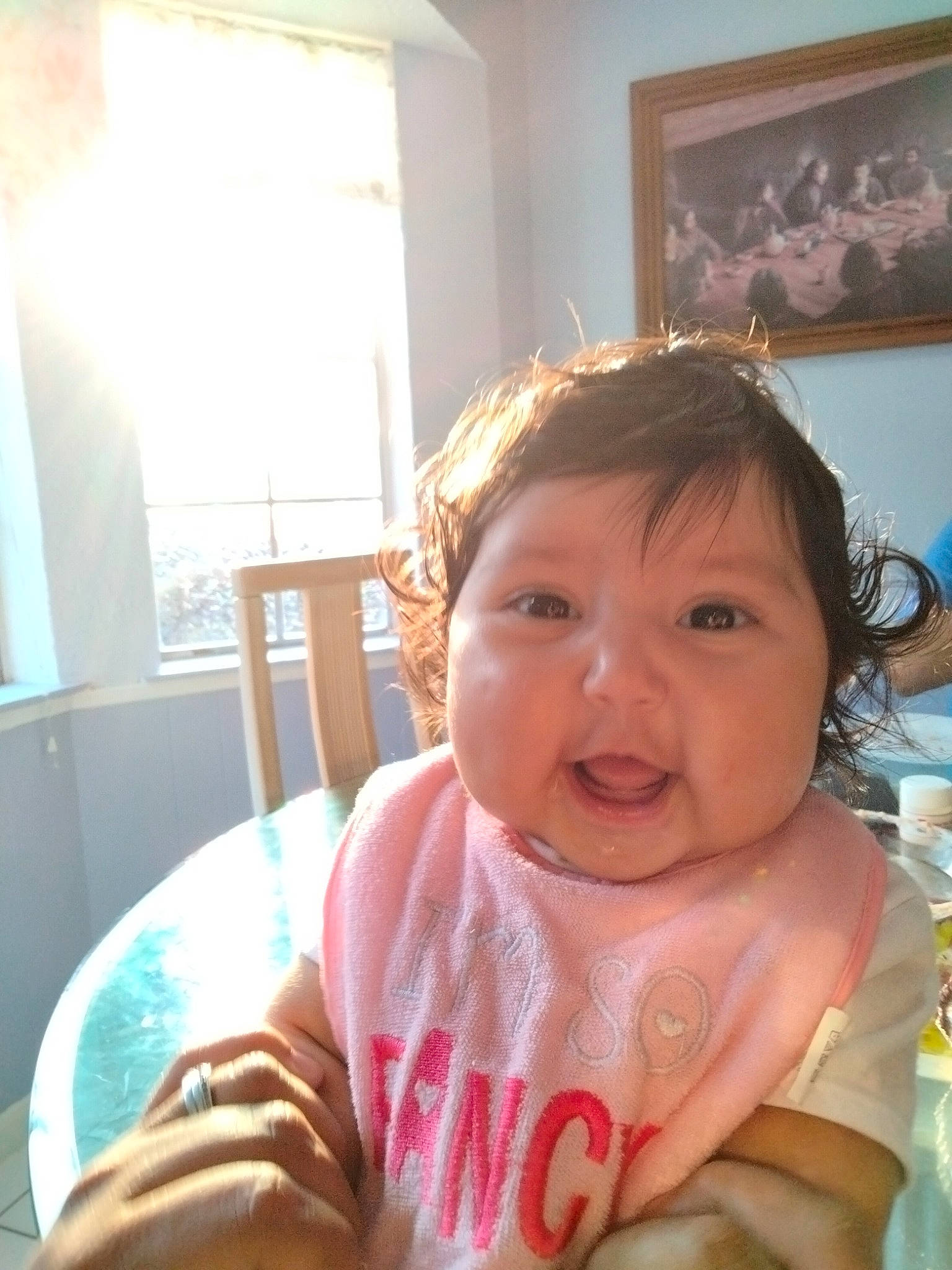 Marisol is registered to the contest to win money with this photo: baby_toddler_clothing, chair, cheek, cool, ear, eyelash, finger, fun, gesture, happy, lip, mouth, nose, person, picture_frame, skin, smile, table, tableware, toddler