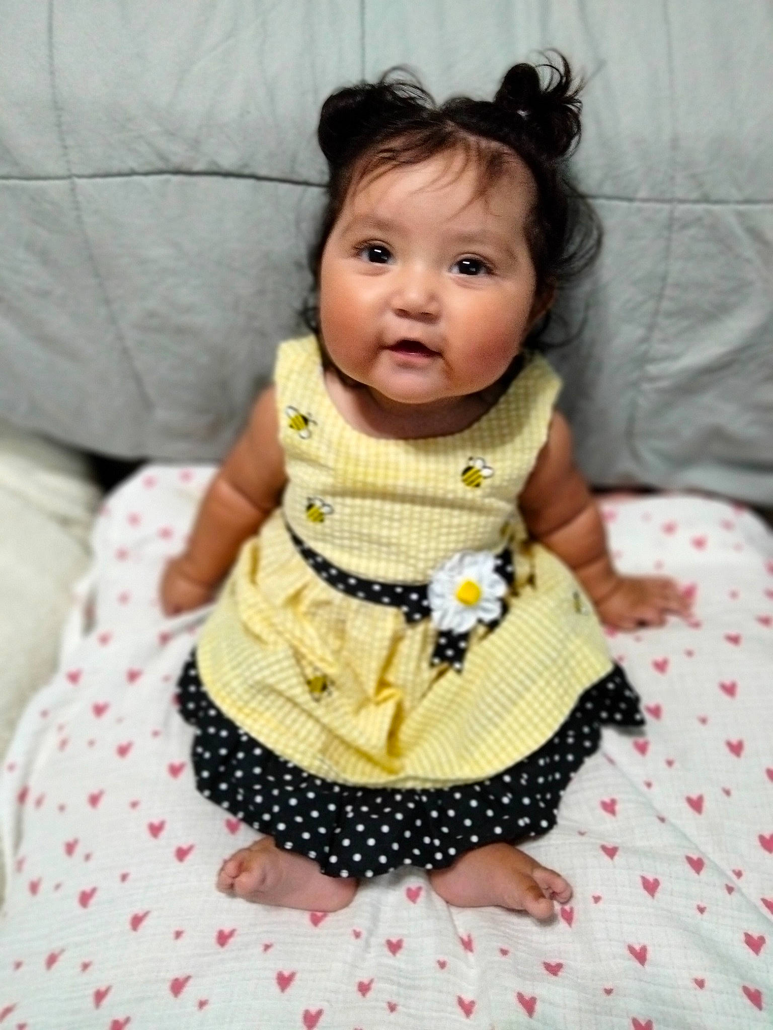 Marisol is registered to the contest to win money with this photo: baby, baby_toddler_clothing, cheek, child, couch, day_dress, doll, dress, eyelash, fashion_accessory, happy, linens, one_piece_garment, pattern, person, pink, sitting, sleeve, textile, toddler