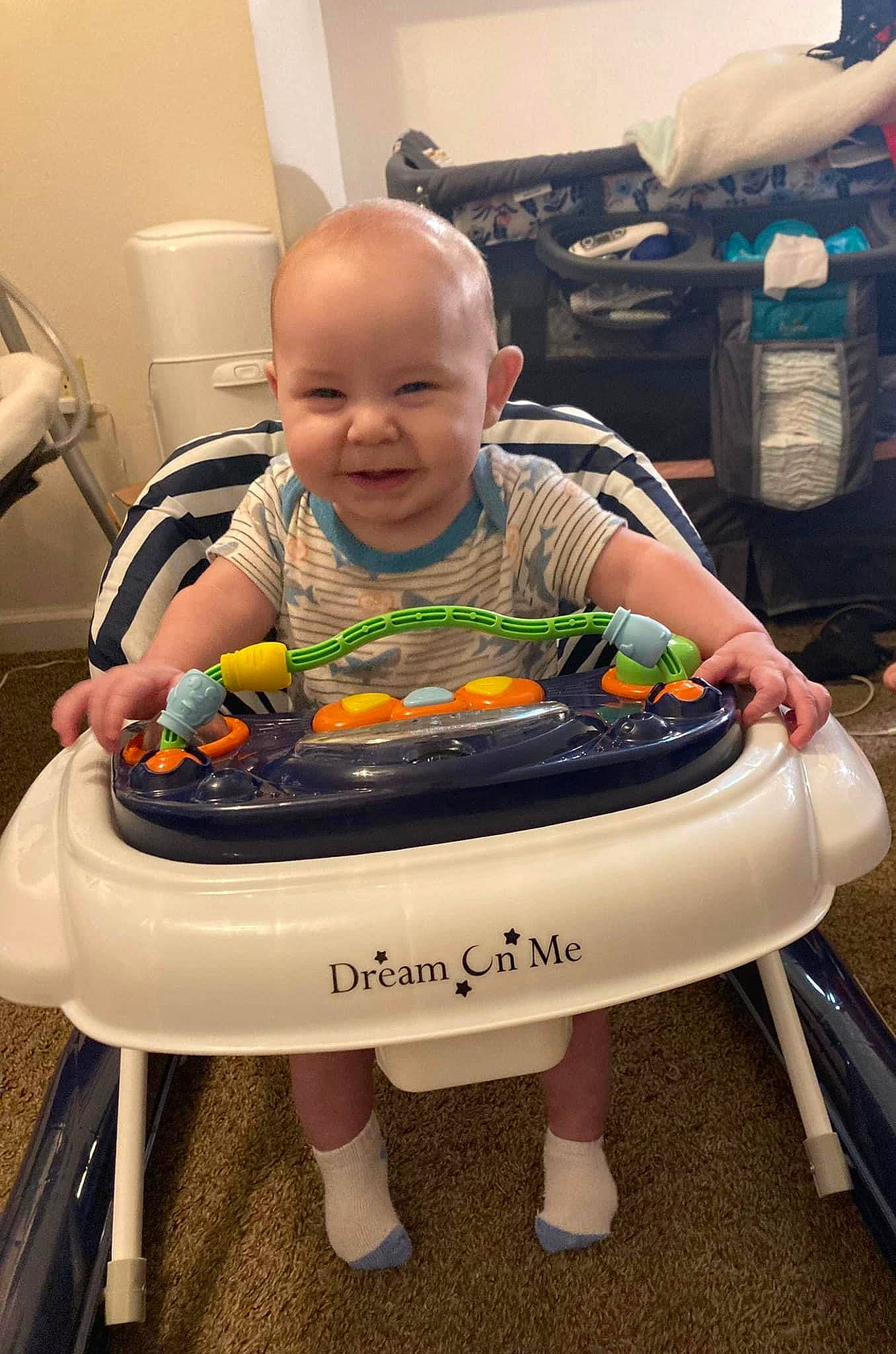 Julian is registered to the contest to win money with this photo: automotive_design, baby, baby_products, baby_toddler_clothing, baby_toys, chair, child, fun, person, play, room, sitting, smile, t_shirt, toddler, toy, toy_vehicle