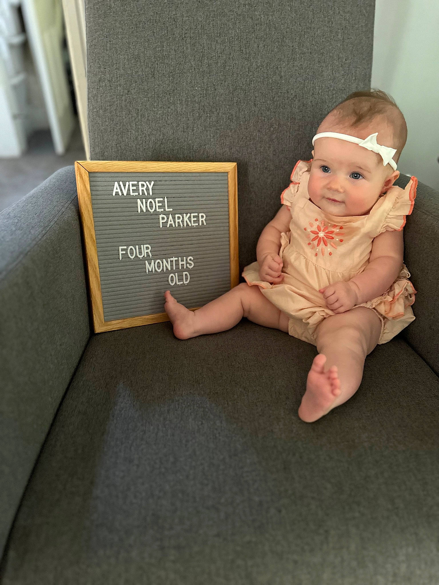 Avery joined the competition — help win amazing prizes! baby, baby_toddler_clothing, book, book_cover, child, comfort, floor, flooring, font, foot, human_body, person, publication, rectangle, room, sitting, sleeve, sock, studio_couch, toddler