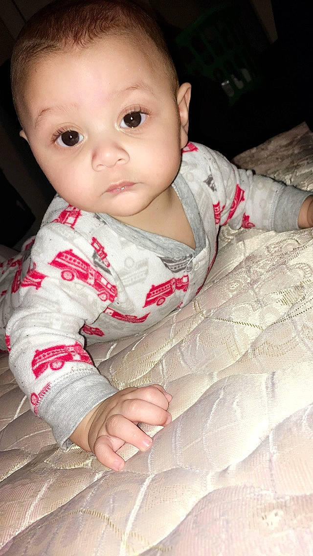 Kelvin Green is registered to the contest to win money with this photo: baby, beauty, cheek, child, chin, eye, face, forehead, hand, head, leg, lip, mouth, nose, person, pink, sitting, skin, smile, toddler