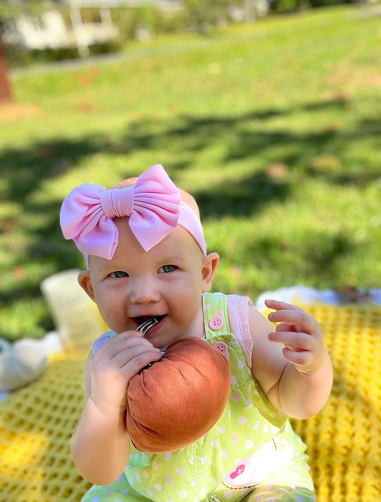 Kassidy is registered to the contest to win money with this photo: baby, baby_toddler_clothing, baseball_cap, cap, child, fashion_accessory, fun, gesture, grass, happy, hat, headwear, leisure, magenta, people_in_nature, person, pink, recreation, sitting, smile