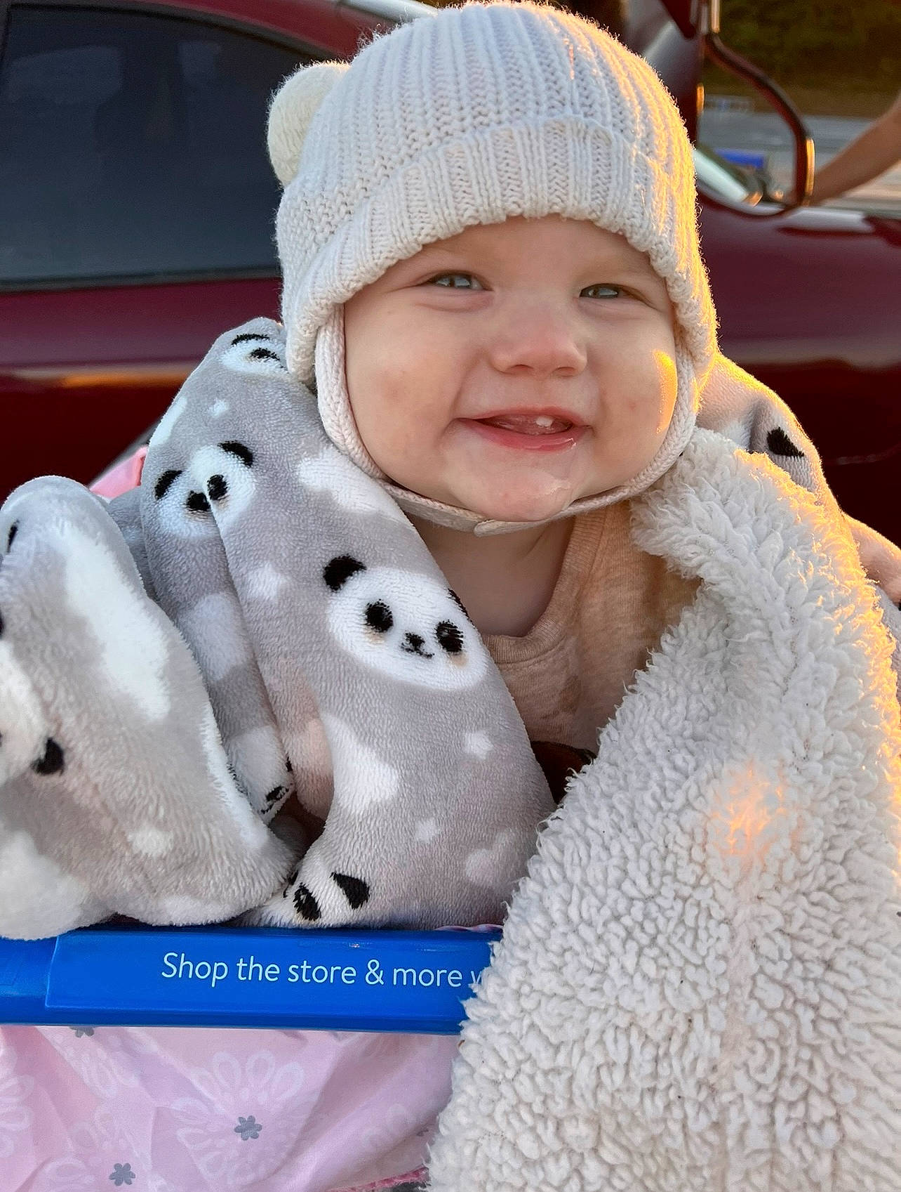 Kassidy joined the competition — help win amazing prizes! baby, baby_toddler_clothing, beanie, cap, child, fun, fur, grass, happy, headwear, knit_cap, outerwear, pattern, person, photograph, plush, smile, textile, toddler, white