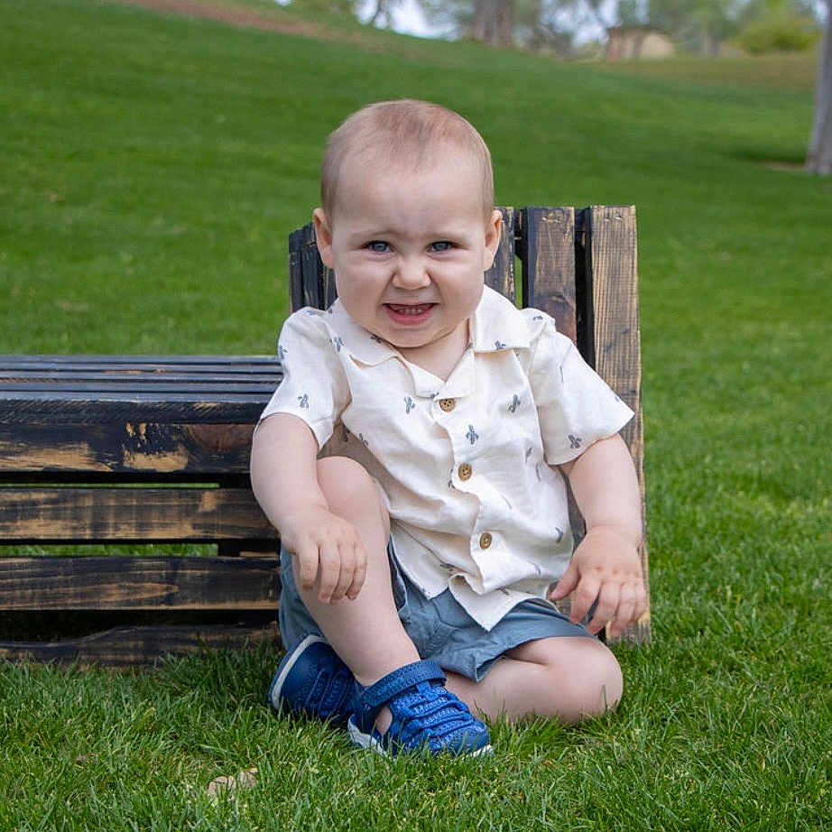 Ian joined the competition — help win amazing prizes! blue_shoes, casual_clothing, child, cute, daylight, expression, grass, greenery, nature, outdoor, park, person, playful, portrait, shirt, sitting, summer, toddler, wooden_bench, young