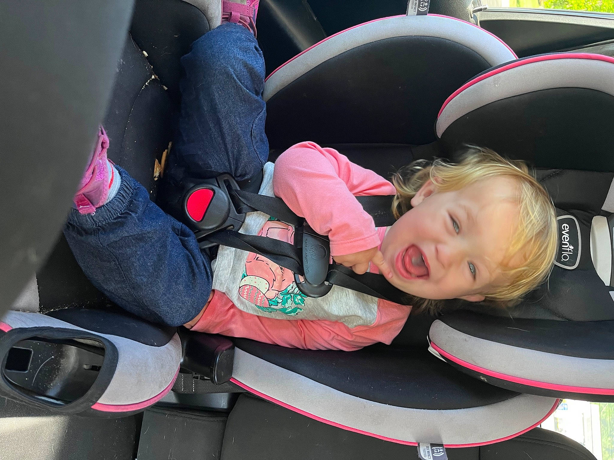 Millie is registered to the contest to win money with this photo: auto_part, automotive_design, automotive_exterior, baby_carriage, baby_products, car_seat, carmine, child, comfort, family_car, fun, luxury_vehicle, motor_vehicle, person, personal_protective_equipment, smile, steering_part, steering_wheel, toddler, vehicle_door