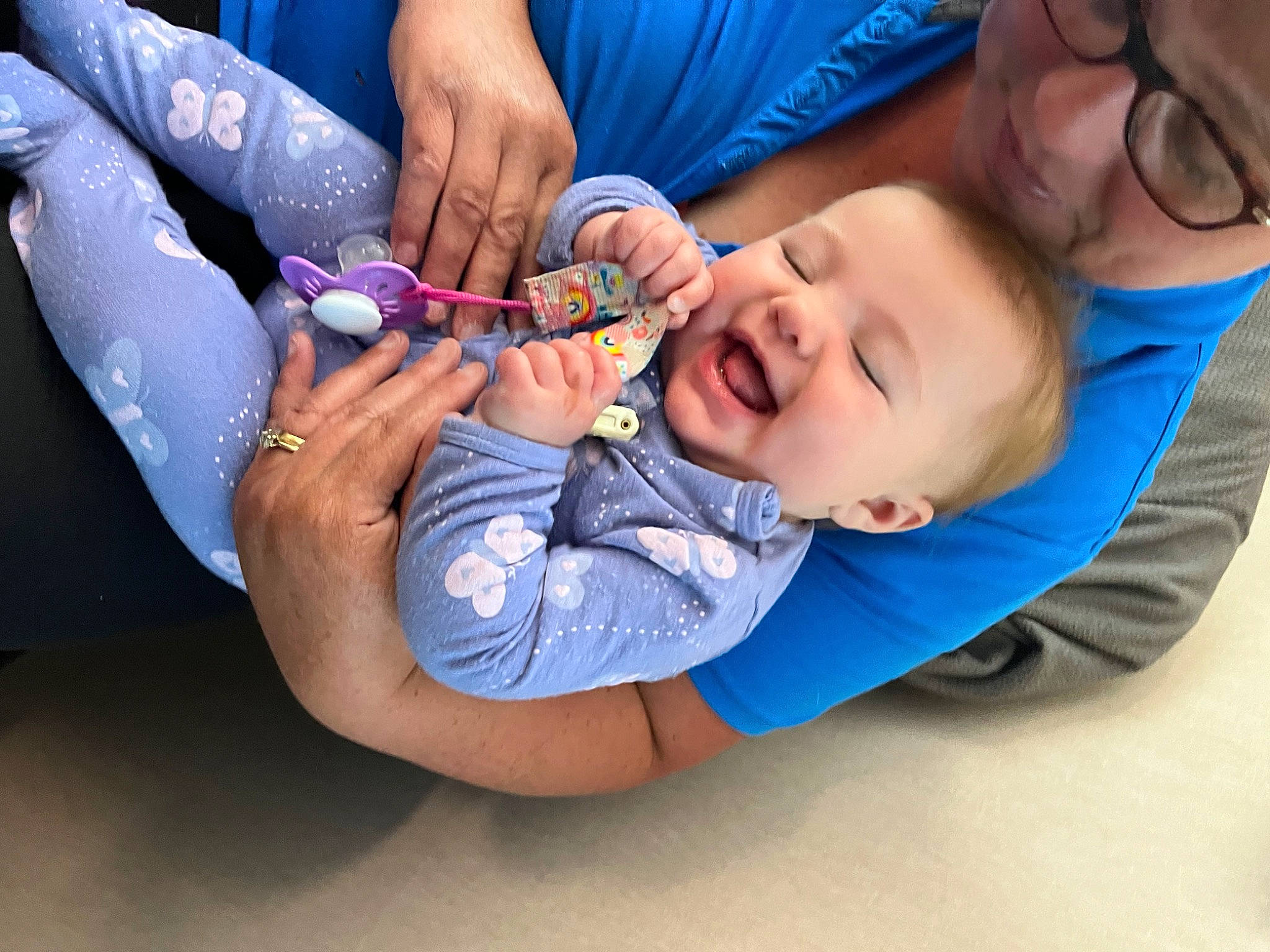Amelia is registered to the contest to win money with this photo: arm, baby, baby_toddler_clothing, blue, child, comfort, electric_blue, event, finger, gesture, hand, happy, headwear, health_care, mouth, nail, person, skin, smile, thumb