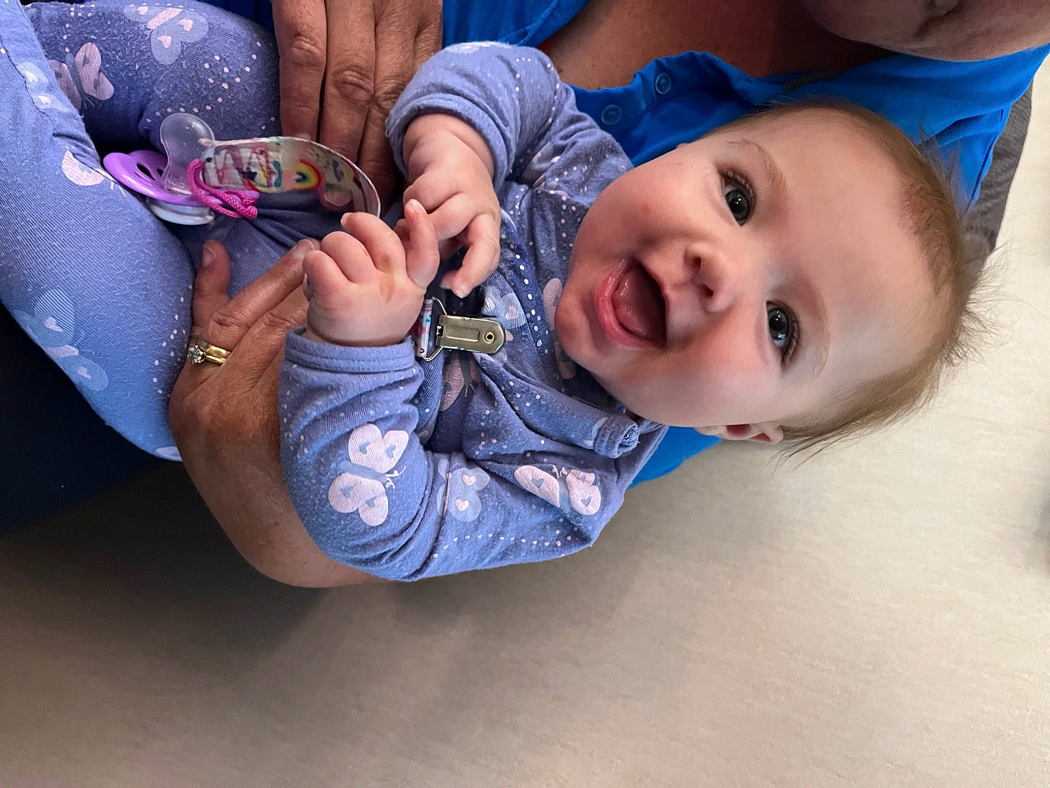 Amelia is registered to the contest to win money with this photo: baby, baby_toddler_clothing, child, comfort, elbow, electric_blue, eye, fashion_accessory, foot, fun, gesture, happy, leisure, luggage_and_bags, nail, person, sitting, skin, smile, toddler