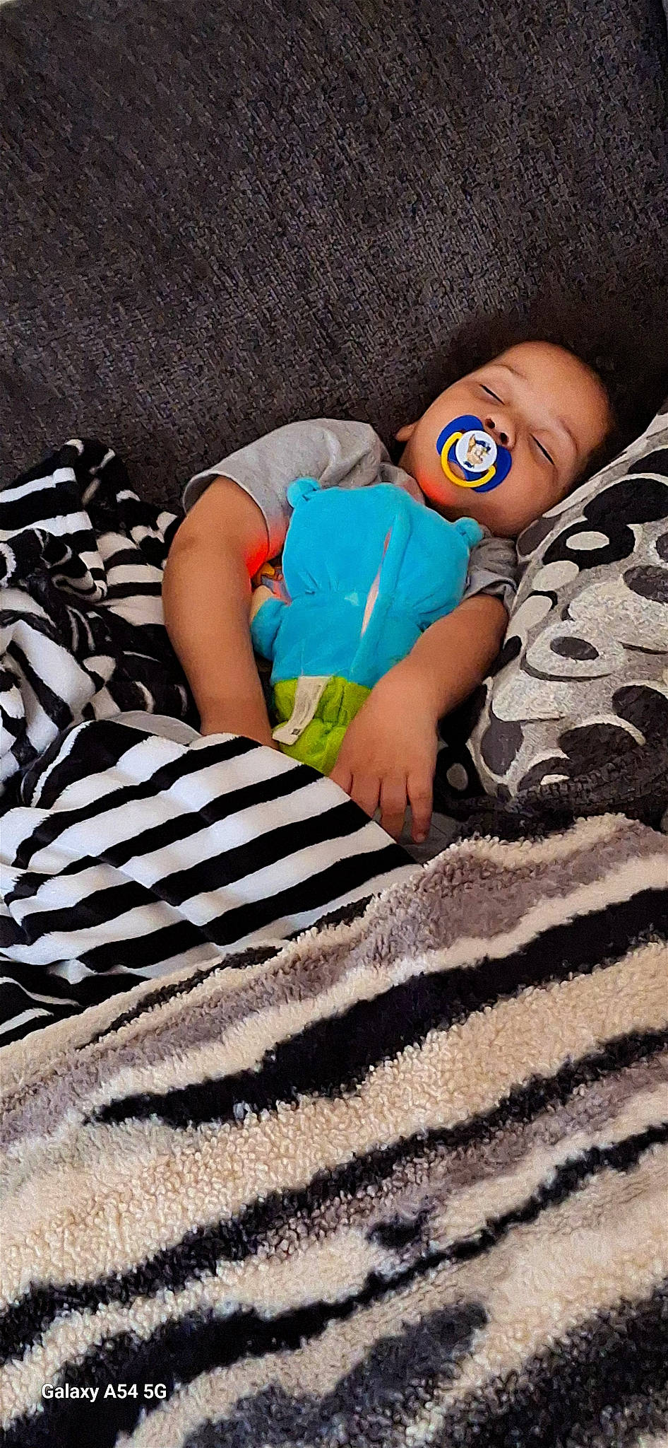 Adonis is registered to the contest to win money with this photo: azure, baby, baby_sleeping, baby_toddler_clothing, beauty, child, comfort, electric_blue, foot, human_leg, leg, linens, nail, pattern, person, sleeve, t_shirt, textile, thigh, toddler
