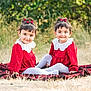 toddler, child, twins, red_dress, white_collar, hair_accessory, smiling, outdoor, grass, blanket, sitting, cute, portrait, happy, nature, female, young_child, playful, matching_outfits, daylight
