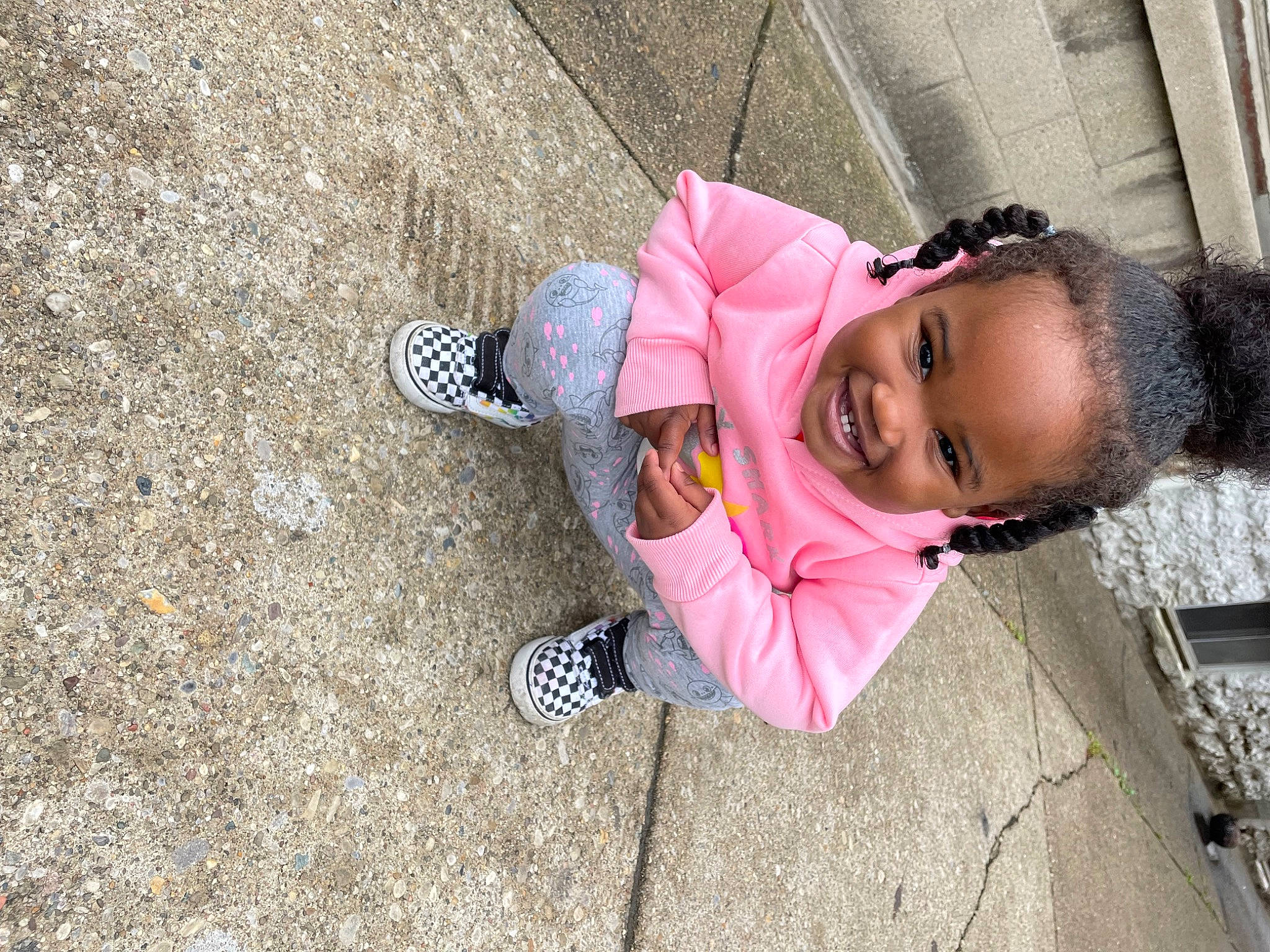 Zariah joined the competition — help win amazing prizes! boot, child, city, concrete, flooring, foot, fun, grass, joy, leisure, outdoor_shoe, person, recreation, road_surface, sandal, sidewalk, sitting, smile, street_fashion, toddler