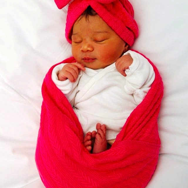 Séora is registered to the contest to win money with this photo: baby, blanket, child, cozy, cute, feet, hands, headwrap, indoors, infant, newborn, peaceful, portrait, red, resting, sleeping, soft, tiny, white_background, wrapped