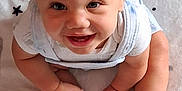 Marquis Junior joined the competition — help win amazing prizes! baby, blanket, child, clothing, cute, face, feet, hands, happy, indoors, infant, light, person, portrait, sitting, skin, smiling, stars, white_socks, young