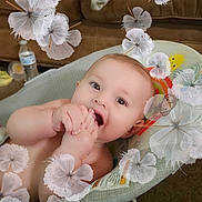 Kayson is registered to the contest to win money with this photo: baby, child, foot, chewing, baby_rocker, face, happy, living_room, couch, water_bottle, carpet, clothing, patterned_socks, toy, smiling, portrait, indoor, skin, hand, feet