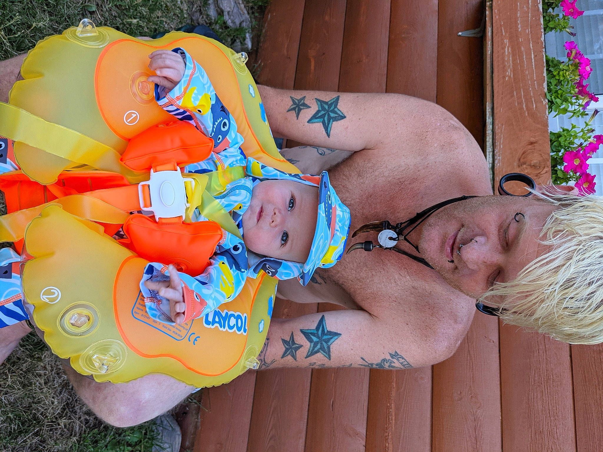 Richie is registered to the contest to win money with this photo: abdomen, arm, child, fun, glasses, grass, hand, happy, head, headwear, human_body, leisure, muscle, orange, people_in_nature, person, plant, sunglasses, textile, thigh