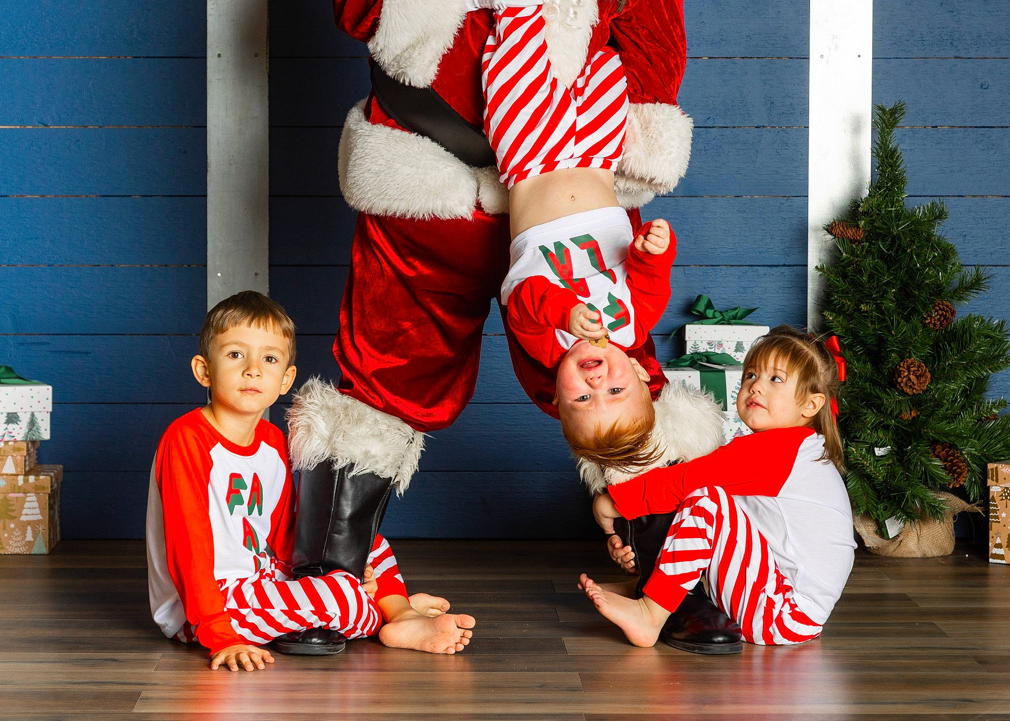 Bailey is registered to the contest to win money with this photo: carmine, child, christmas, christmas_decoration, christmas_eve, christmas_tree, event, facial_expression, fun, happy, holiday, human_leg, knee, person, shorts, smile, sportswear, t_shirt, thigh, toddler