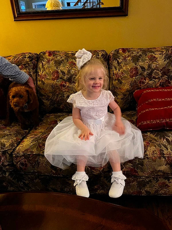 Kallie is registered to the contest to win money with this photo: art, baby_toddler_clothing, child, comfort, couch, event, flooring, fun, happy, joy, lamp, living_room, person, picture_frame, room, sitting, smile, television, television_set, throw_pillow