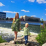 Elijah joined the competition — help win amazing prizes! woman, child, river, waterfall, rocks, green_dress, plaid_shirt, jeans, holding_hands, smiling, outdoor, nature, blue_sky, clouds, plants, daylight, casual_clothing, happy, people, urban_background