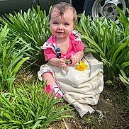 Amarah joined the competition — help win amazing prizes! baby, child, smiling, outdoor, plants, flower, grass, greenery, pink_clothing, sitting, nature, tire, car, vintage_car, sunlight, happy, cute, ground, blanket, person