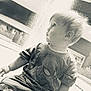 toddler, child, spiderman, shirt, shorts, sitting, indoors, curious, side_profile, soft_light, blond_hair, casual_clothing, young_child, portrait, baby, cute, expression, small_person, monochrome, innocence