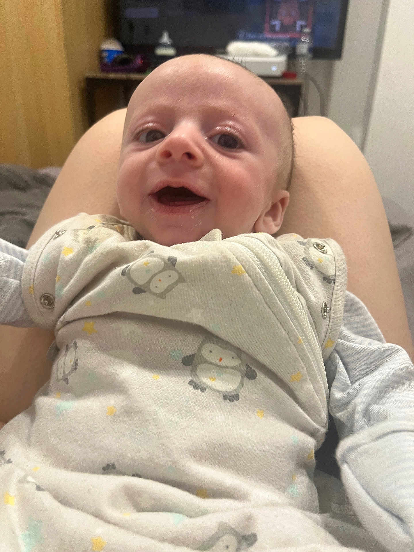 Grayson-Lee joined the competition — help win amazing prizes! baby, infant, smile, happy, clothing, onesie, penguin_pattern, person, face, legs, indoor, bed, blanket, cute, child, young, portrait, closeup, skin, sleeve