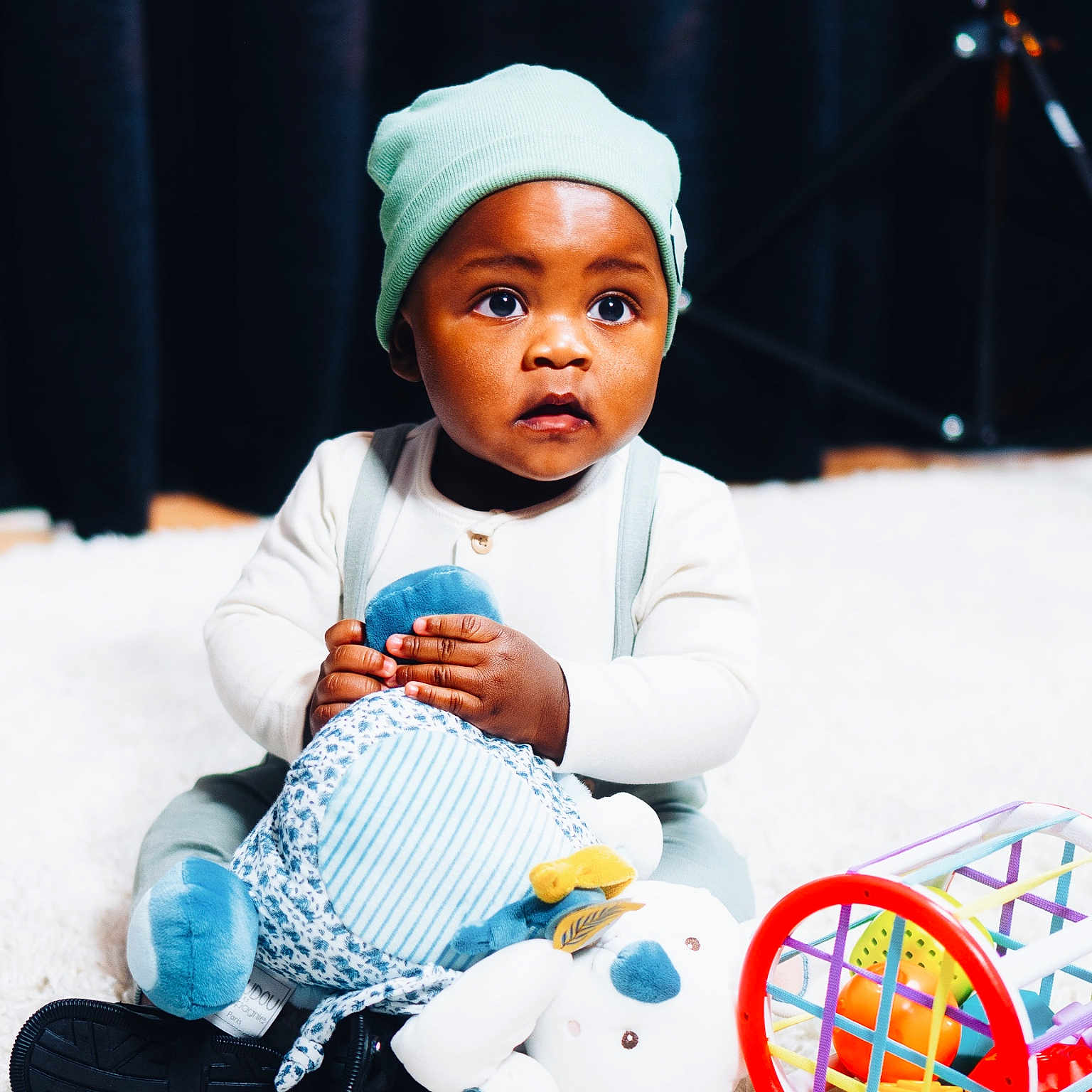 Oluwaferanmi joined the competition — help win amazing prizes! baby, bodypart, bonnet, cap, clothing, couch, doll, face, finger, furniture, hand, happy, hat, head, person, photography, portrait, sitting, smile, toy