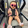 Avalynn joined the competition — help win amazing prizes! baby, child, infant, stroller, sunglasses, pink_clothing, sandals, bows, smiling, portrait, seated, indoors, floor, harness, car_seat, fashion, cute, happy, photography, accessories
