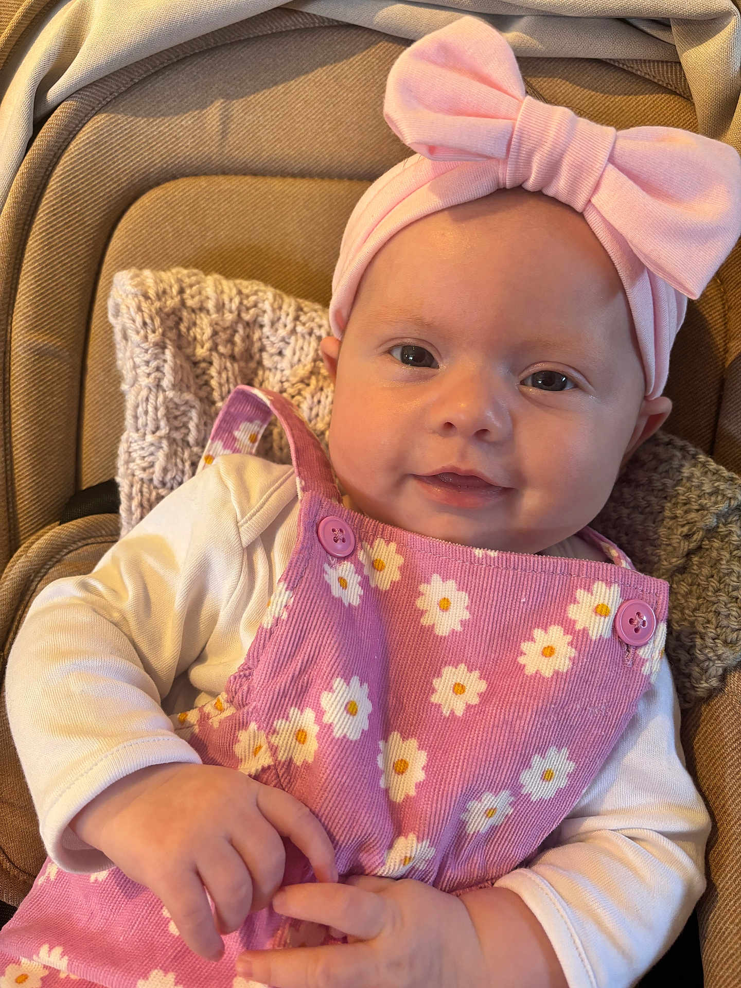 Sofia joined the competition — help win amazing prizes! baby, infant, pink_outfit, headband, bow, smiling, cute, knitted_blanket, cushion, closeup, portrait, child, indoor, clothing, happy, face, hands, person, soft_lighting, baby_girl